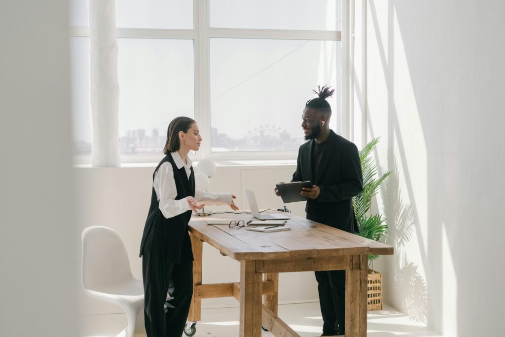 A man and a woman talking face-to-face, illustrating direct marketing in action.
